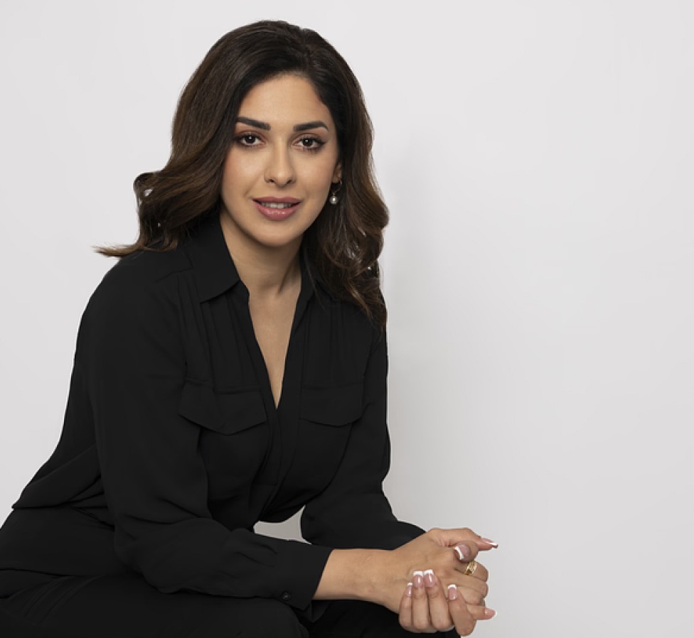 Sahar Mousavi, an immigration lawyer and attorney, posing in a professional black outfit against a white background, representing legal expertise and client advocacy.